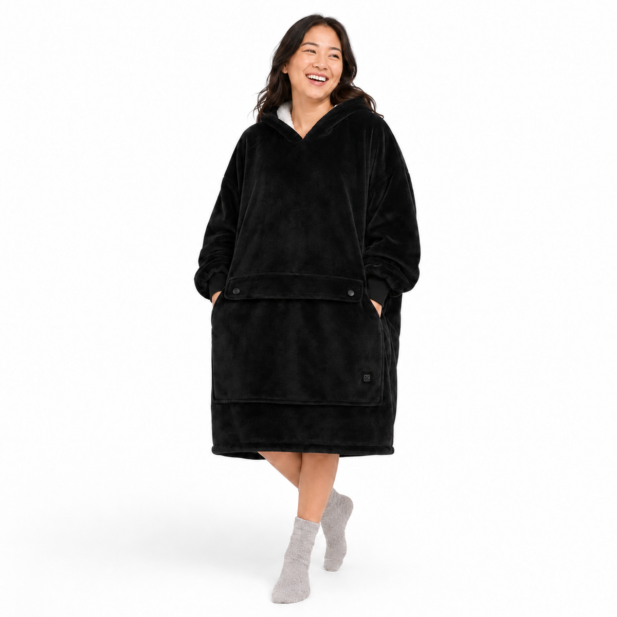 Black BardiHeat heated fleece worn in a playful studio pose with two pocket-closing buttons