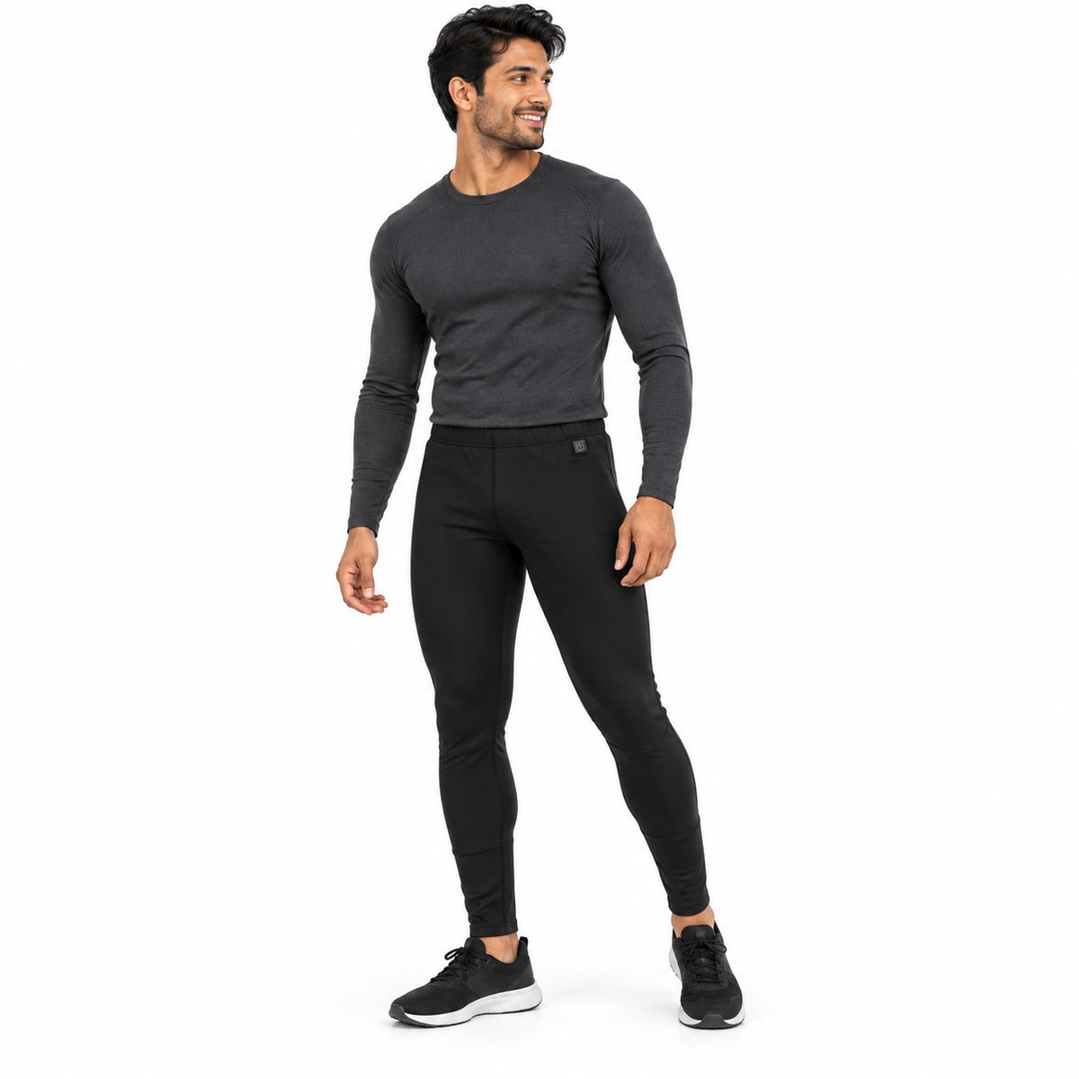 Model wearing men's black Heated Thermal Trousers in a white studio