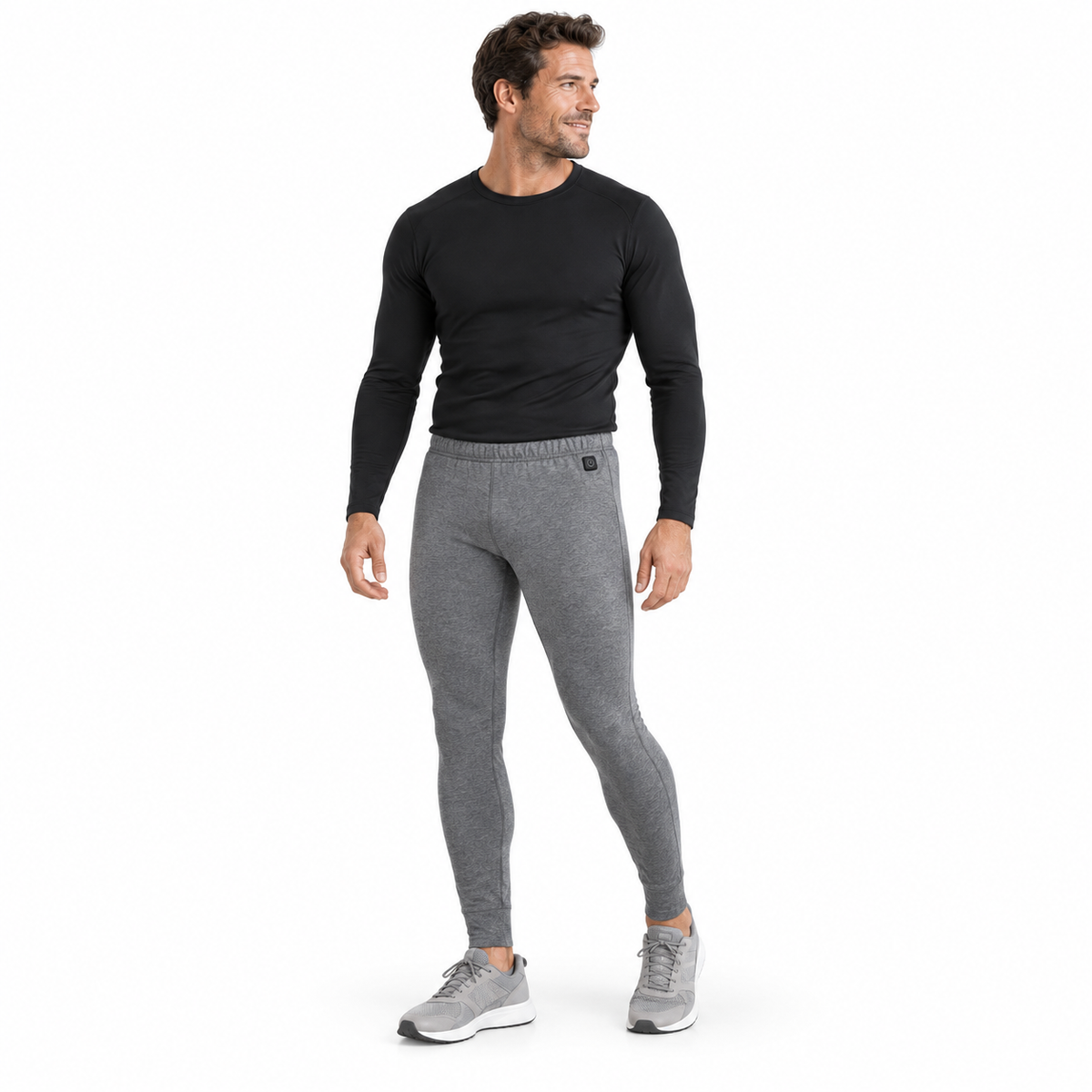 Model wearing men's grey Heated Thermal Trousers in a white studio